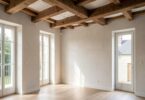 Intérieur de maison rénovée avec poutres apparentes et lumière naturelle traversant de nouvelles fenêtres